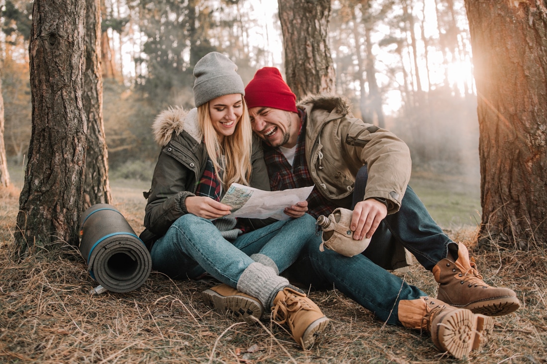 camping couple laughing by the fire, denver therapy for healthy relationships