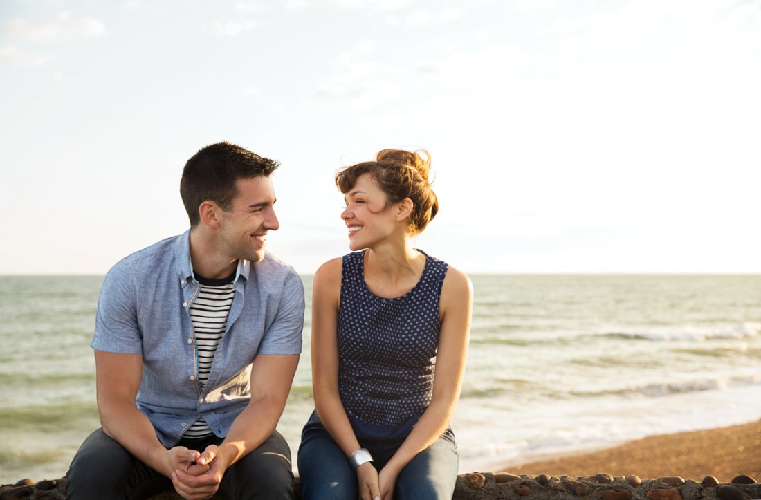 Man and woman enjoying a date by the water