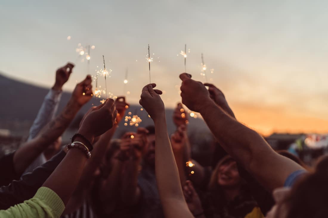 breakup and divorce recovery coaching group celebrating with sparklers in the air