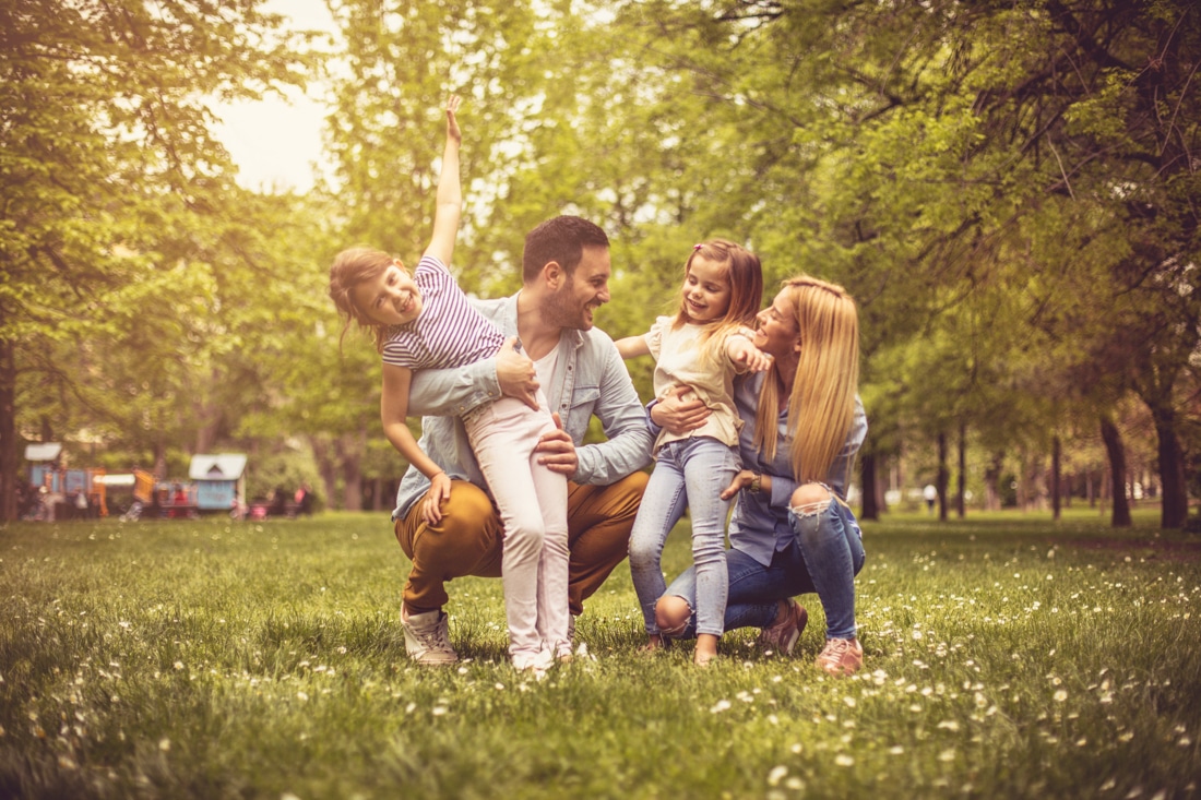 family playing in park, thriving relationships and emotional intelligence