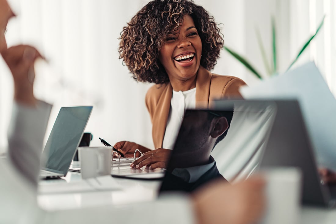 Portrait of cheerful young businesswoman laughing - career coaching, life coaching