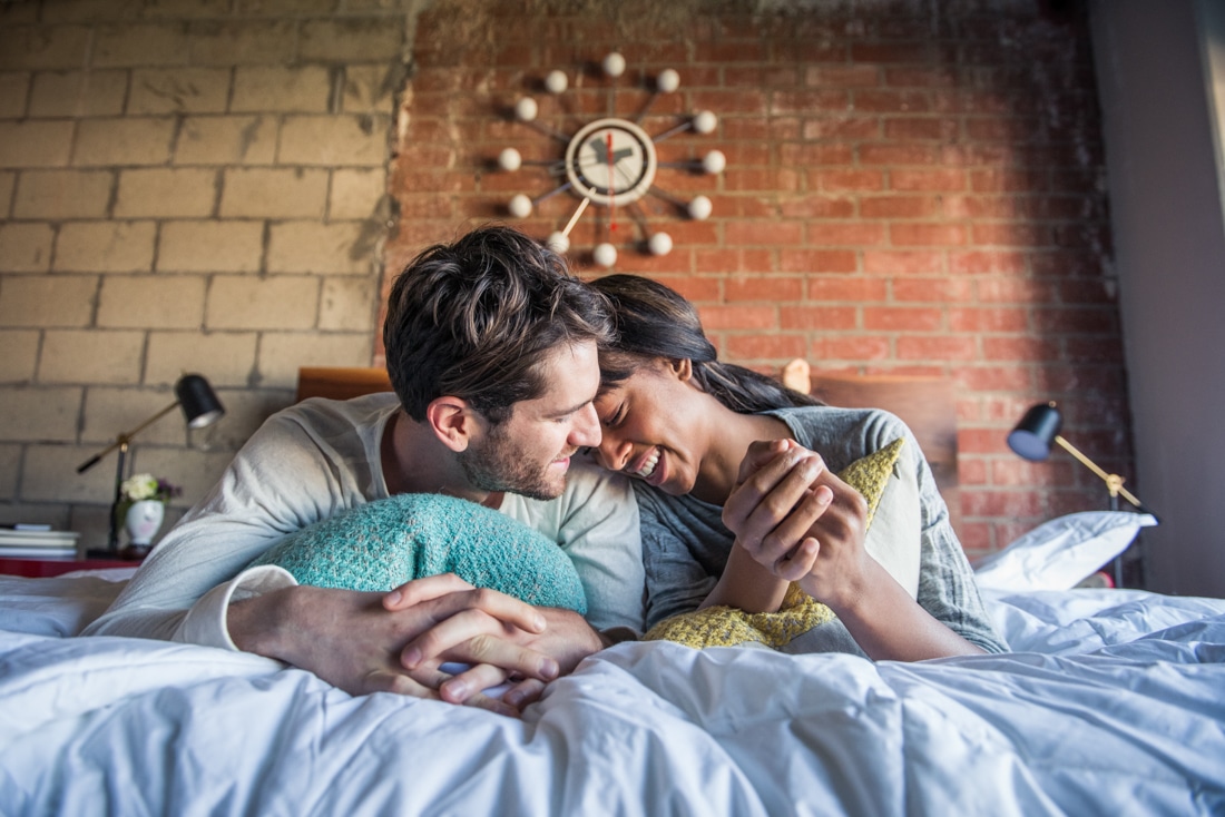 Couple in Bed Engaged in Pillow talk - Life Coaching and Relationship Coaching