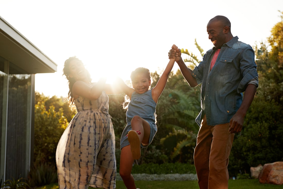 Parents playing with their kids representing parenting coach and family therapy services