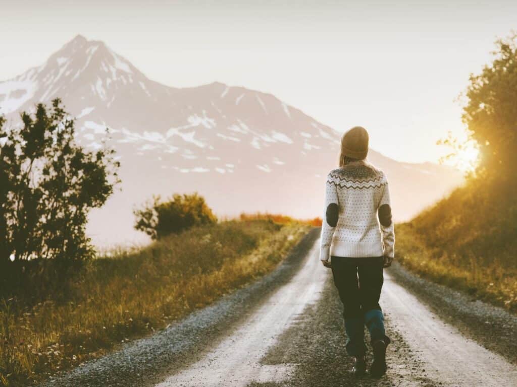 Someone embracing uncertainty by walking into the unknown