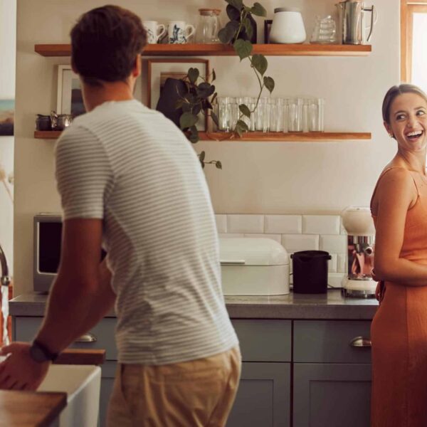 Photo of happy couple doing housework representing equality in relationships