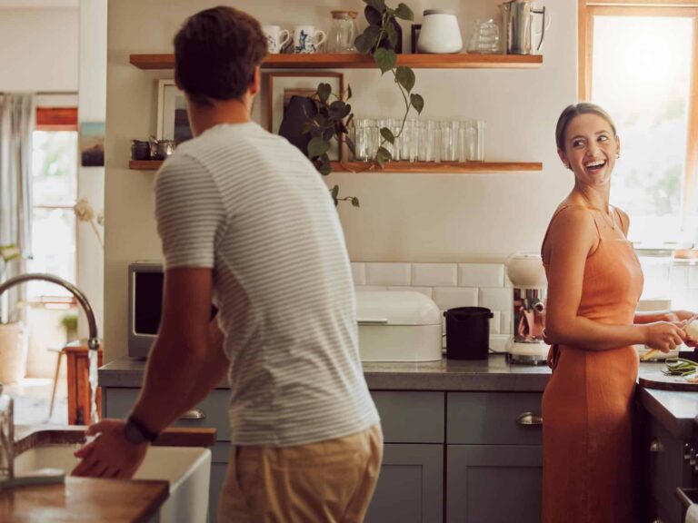 Photo of happy couple doing housework representing equality in relationships