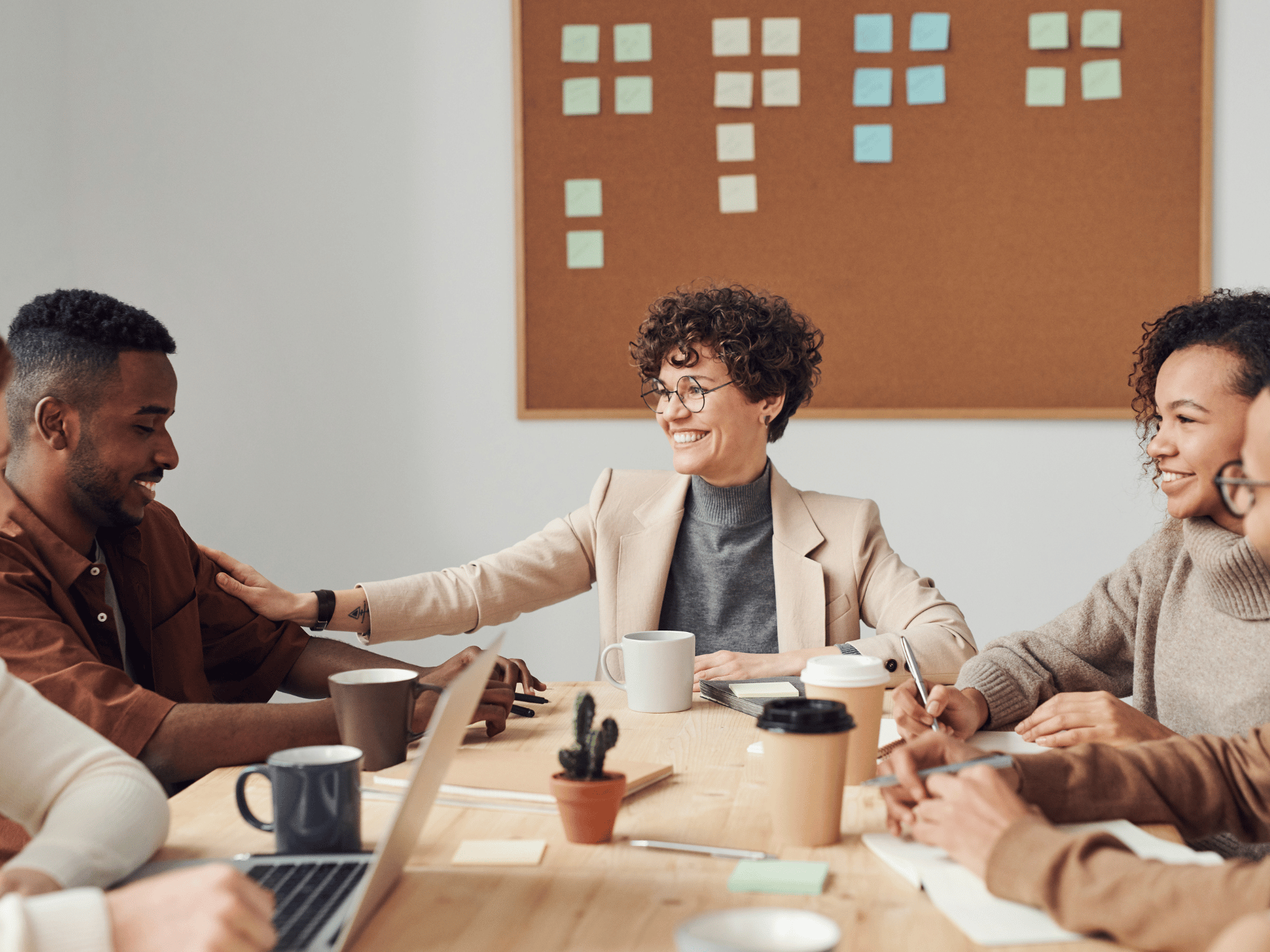 Team collaborating and woman representing how to be a good boss