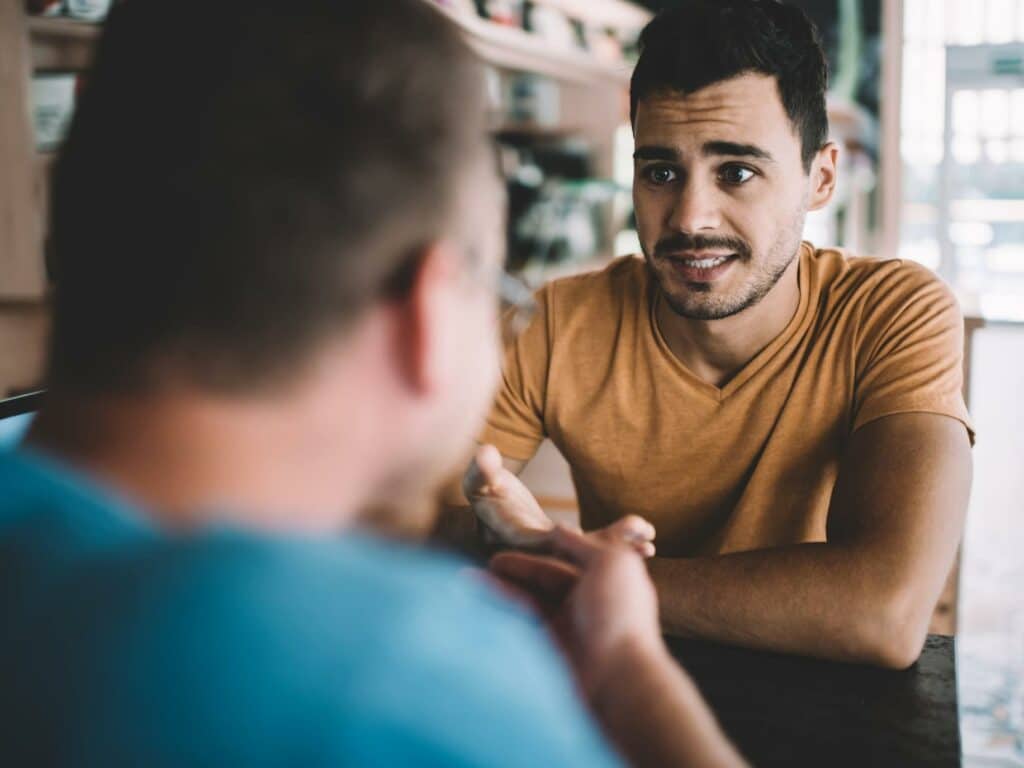 Photo of a man looking worried as he uncovers red flags in a relationship.