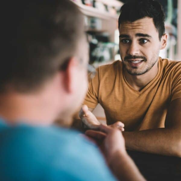 Photo of a man looking worried as he uncovers red flags in a relationship.