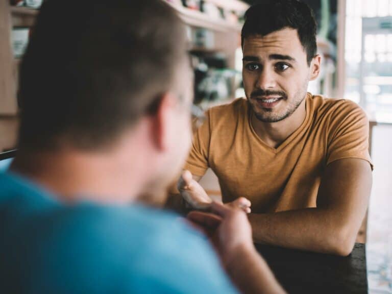 Photo of a man looking worried as he uncovers red flags in a relationship.