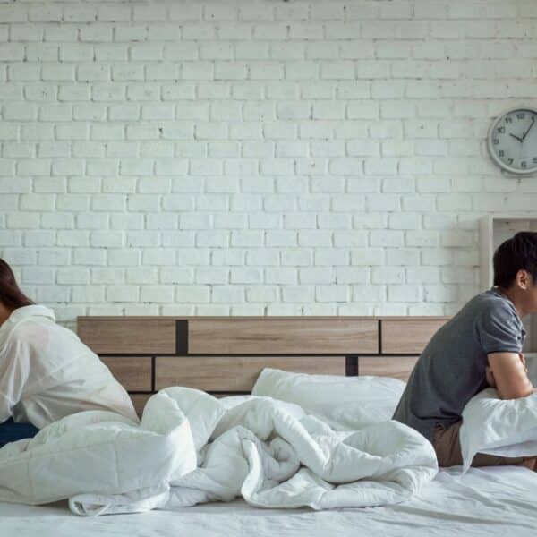 asian couple sitting on opposite sides of bed upset - so you cheated, now what