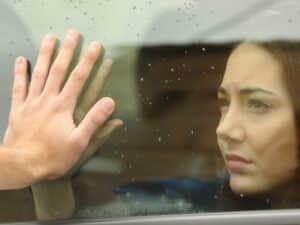 Woman saying goodbye thinking about how to detach from someone you love