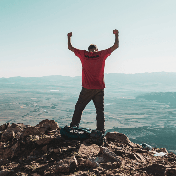 Making it to the top of a mountain, representing overcoming doubt and changing your mindset.