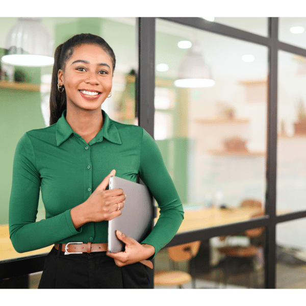 A woman holds a binder and looks satisfied at work representing how to make a career transition