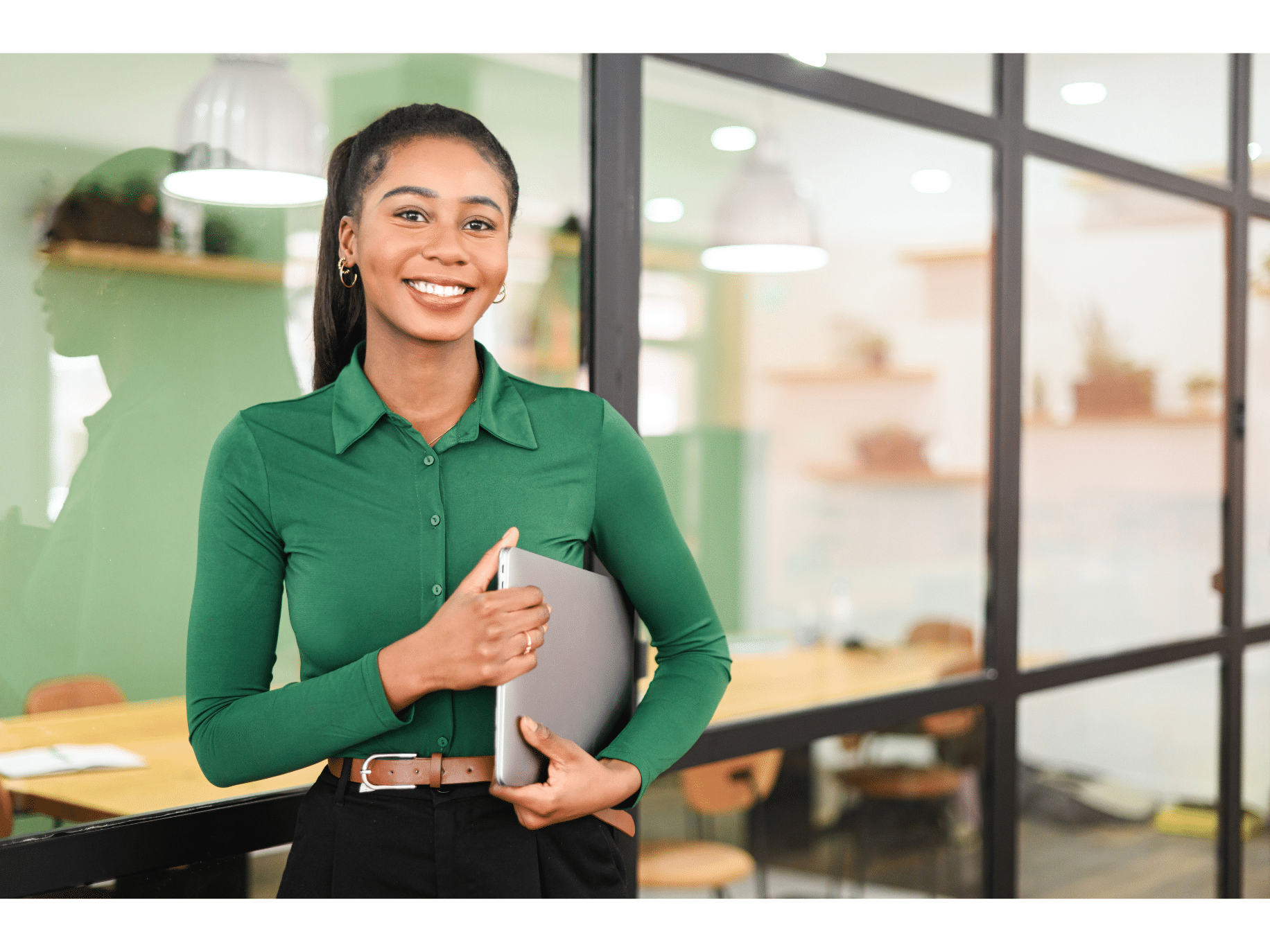 A woman holds a binder and looks satisfied at work representing how to make a career transition