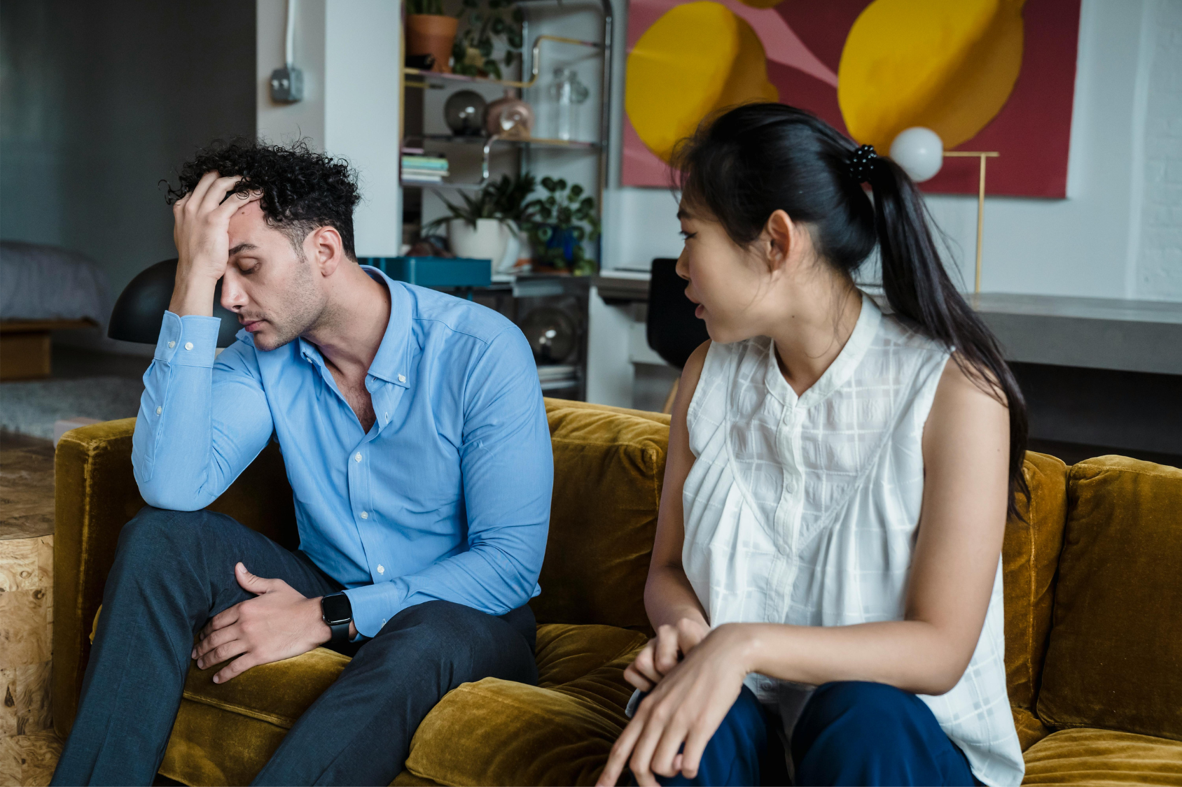 A couple argues on the couch representing signs your relationship is failing