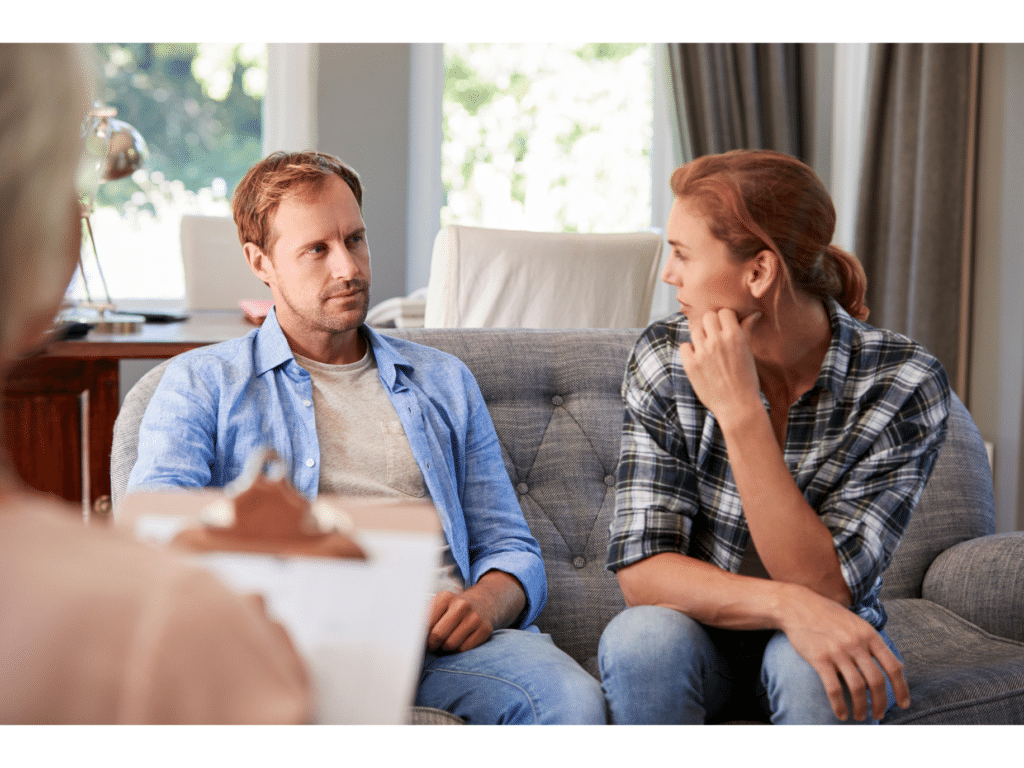 A couple has a tense conversation representing things that sabotage marriage counseling
