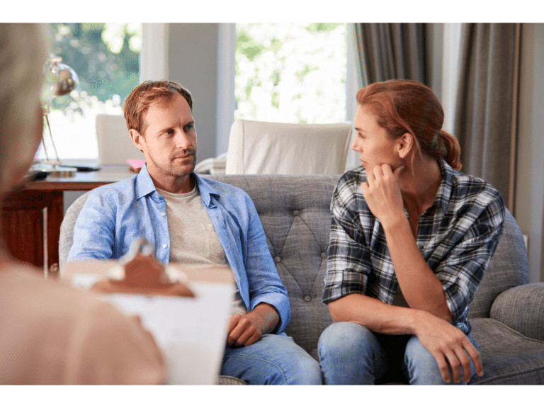 A couple has a tense conversation representing things that sabotage marriage counseling