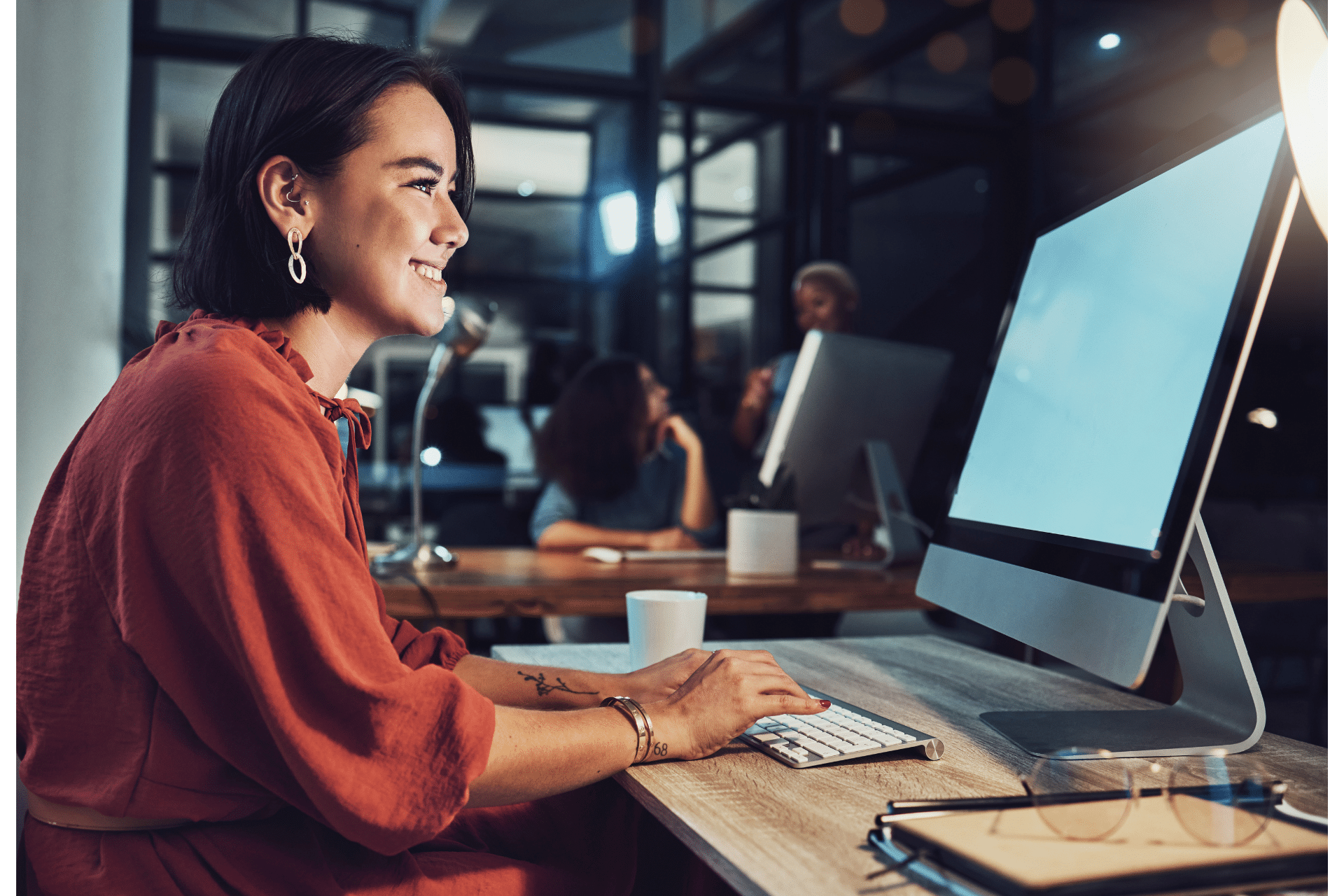 A woman working on a computer representing why you need a professional development plan