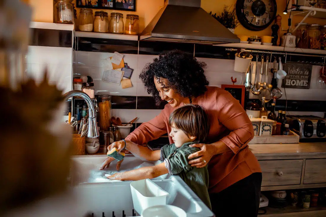 Step mother helping young child, representing blended family counseling outcomes.