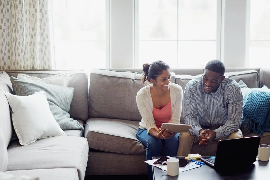 Man and Woman Look at a Tablet