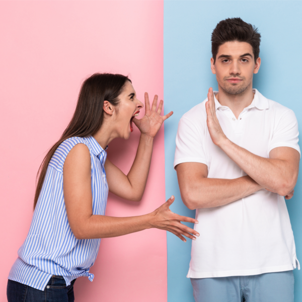 A woman screams at a man who is ignoring her, representing how to connect with an emotionally unavailable partner