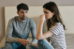 A couple sits down and having a conflict representing reacting versus responding