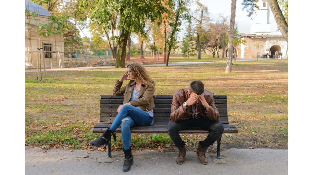 a couple sits on a bench looking upset. recognizing toxic relationships