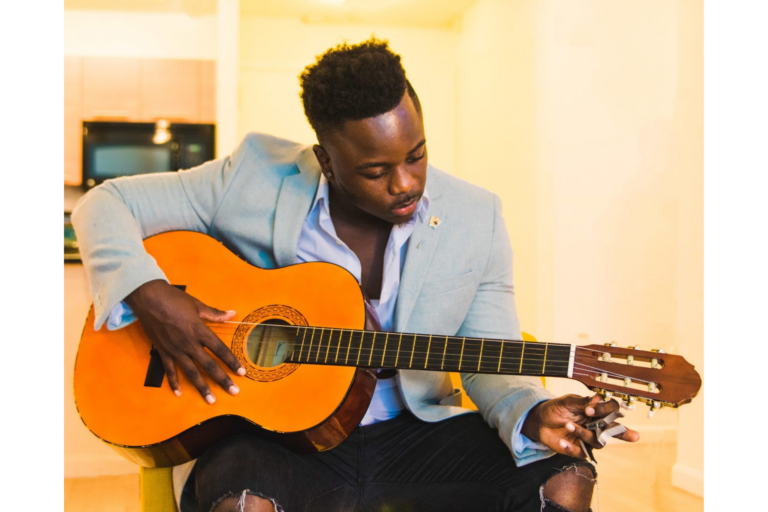 A man plays a guitar representing how to discover your strengths