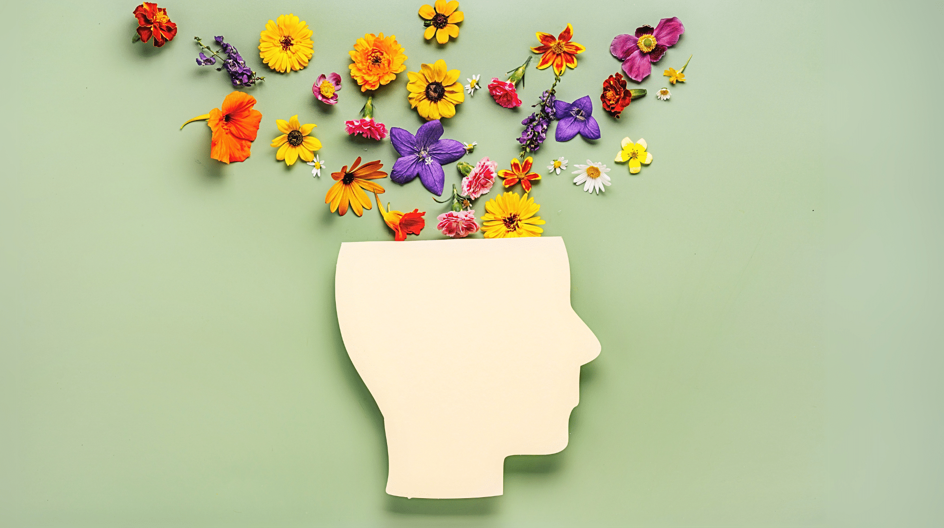 a paper cutout of the side profile of a head with flowers coming out of the top of it representing why therapists need to grow too.