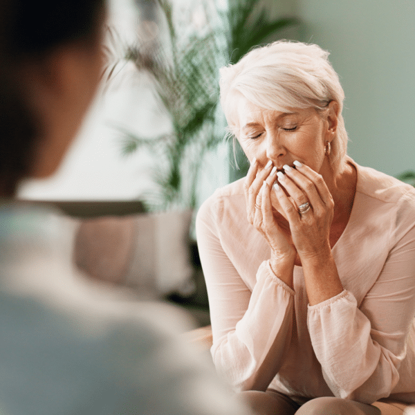 A therapist reacts to a client with her hands over her mouth representing how to deal with vicarious trauma.