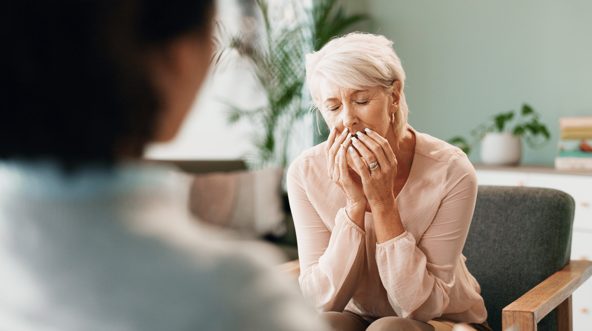 A therapist reacts to a client with her hands over her mouth representing how to deal with vicarious trauma.