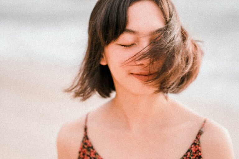 a woman looks happy and peaceful representing how to self-soothe anxious attachment.