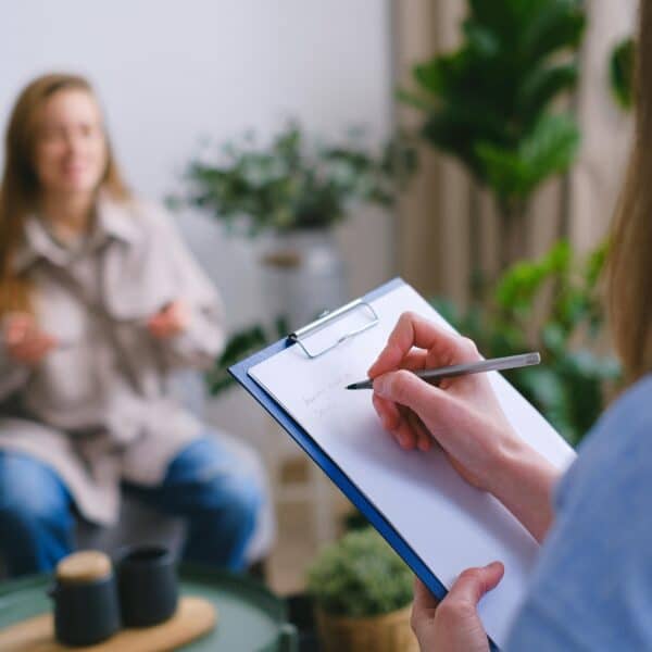 A therapist coaches a client in her office representing Be a Better Therapist by Learning How to Coach