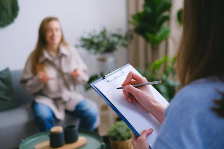 A therapist coaches a client in her office representing Be a Better Therapist by Learning How to Coach