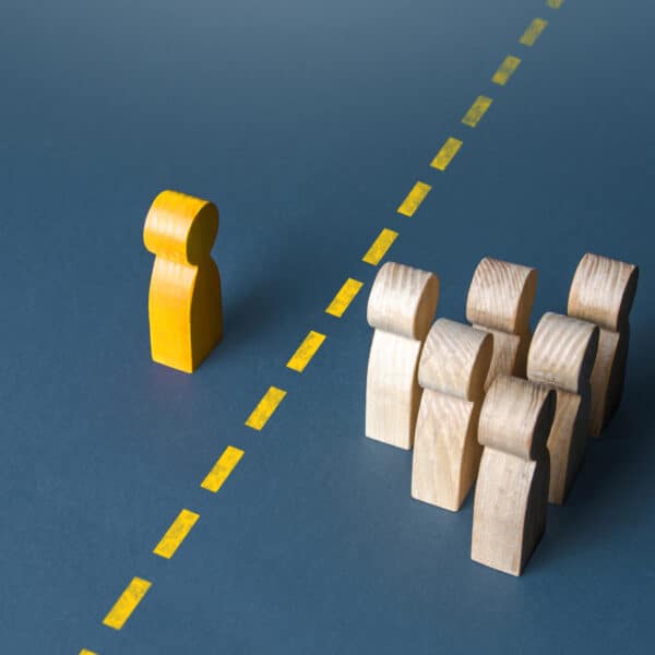 An abstract photo of a yellow figuring setting a boundary with multiple other figurings representing Therapeutic Boundaries for Therapists: Why Your Therapy Clients Think You're Weird