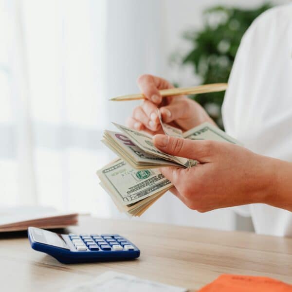 a therapist counts her money representing how therapists can succeed financially.