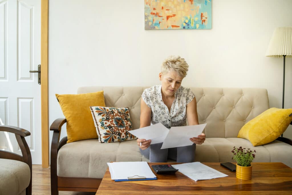 a therapist reviews her case notes and documentation representing The Essential Role of Ongoing Assessment in Therapy
