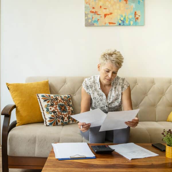 a therapist reviews her case notes and documentation representing The Essential Role of Ongoing Assessment in Therapy