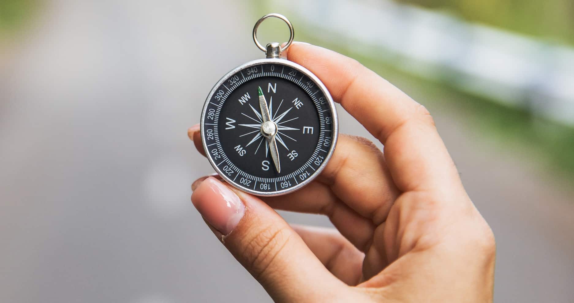 A woman is holding a compass representing Therapist Survival Guide: How to Dodge Ethical Landmines and Keep Your License Safe