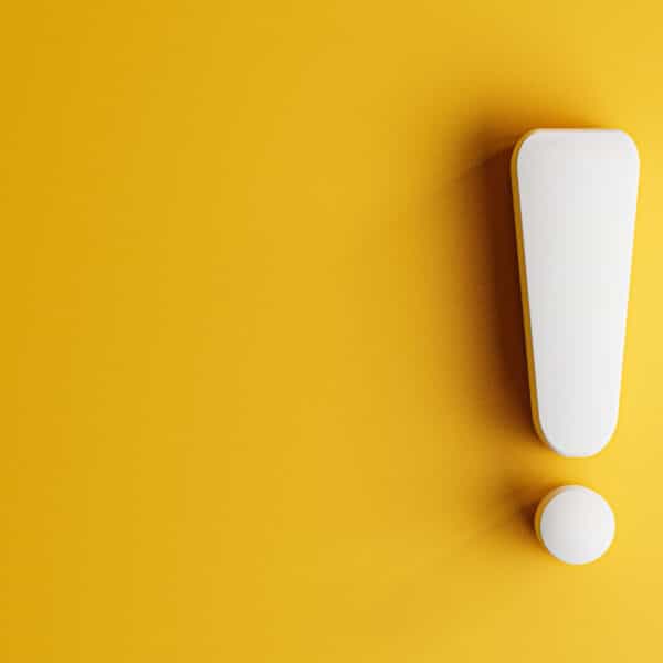 An exclamation point on a yellow background representing The Risks of Therapists Coaching Without Certification.