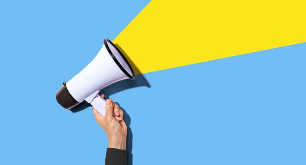 A person holding a megaphone representing what happens when you stand up for yourself.