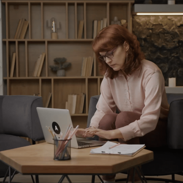 A therapy client types a review of a therapist on her laptop representing Is Your New Client A Mystery Shopper?