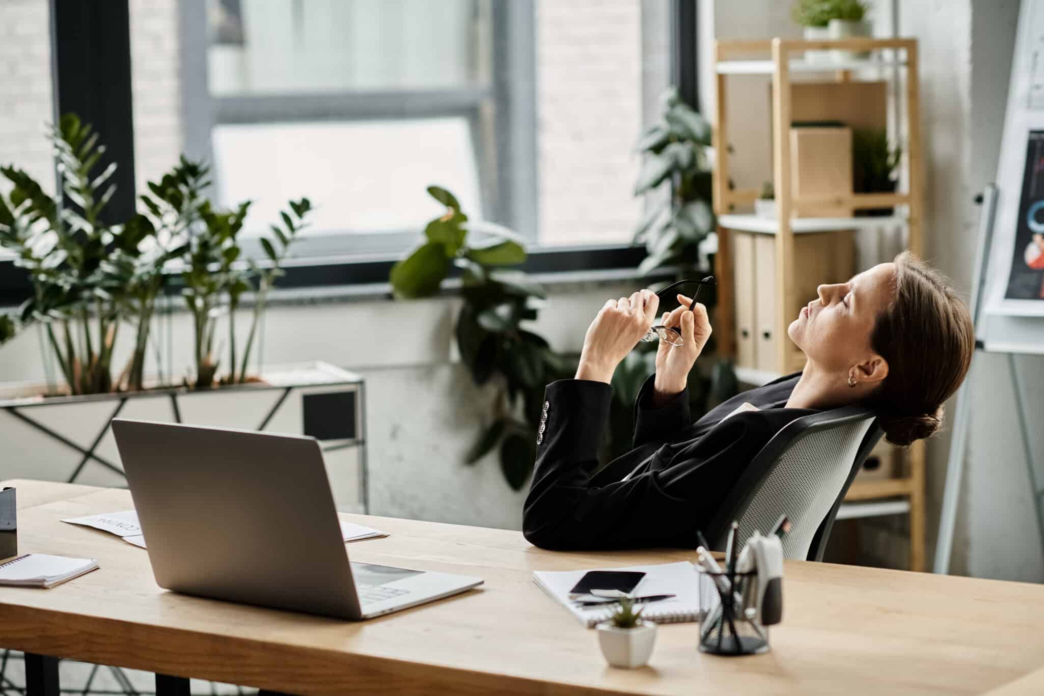 A female therapist sits exhausted at her desk representing When Helping Others Starts to Hurt You: Therapist Burnout.