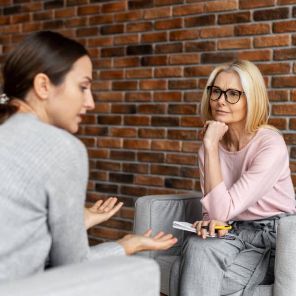 A therapists sits across from her client and contemplates what they are saying representing Therapist Scope of Competence: Recognizing When You’re Out of Your Depth