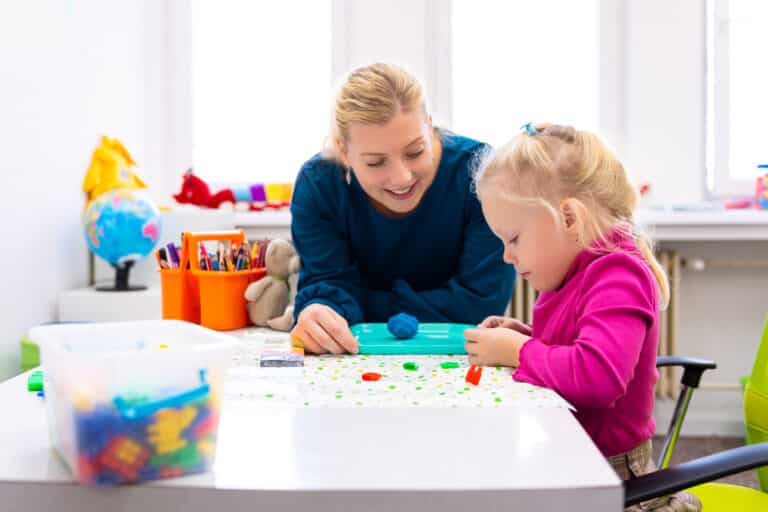 A female therapist plays with a child representing How Child-Centered Play Therapy (CCPT) Can Change the Way You Work with Kids
