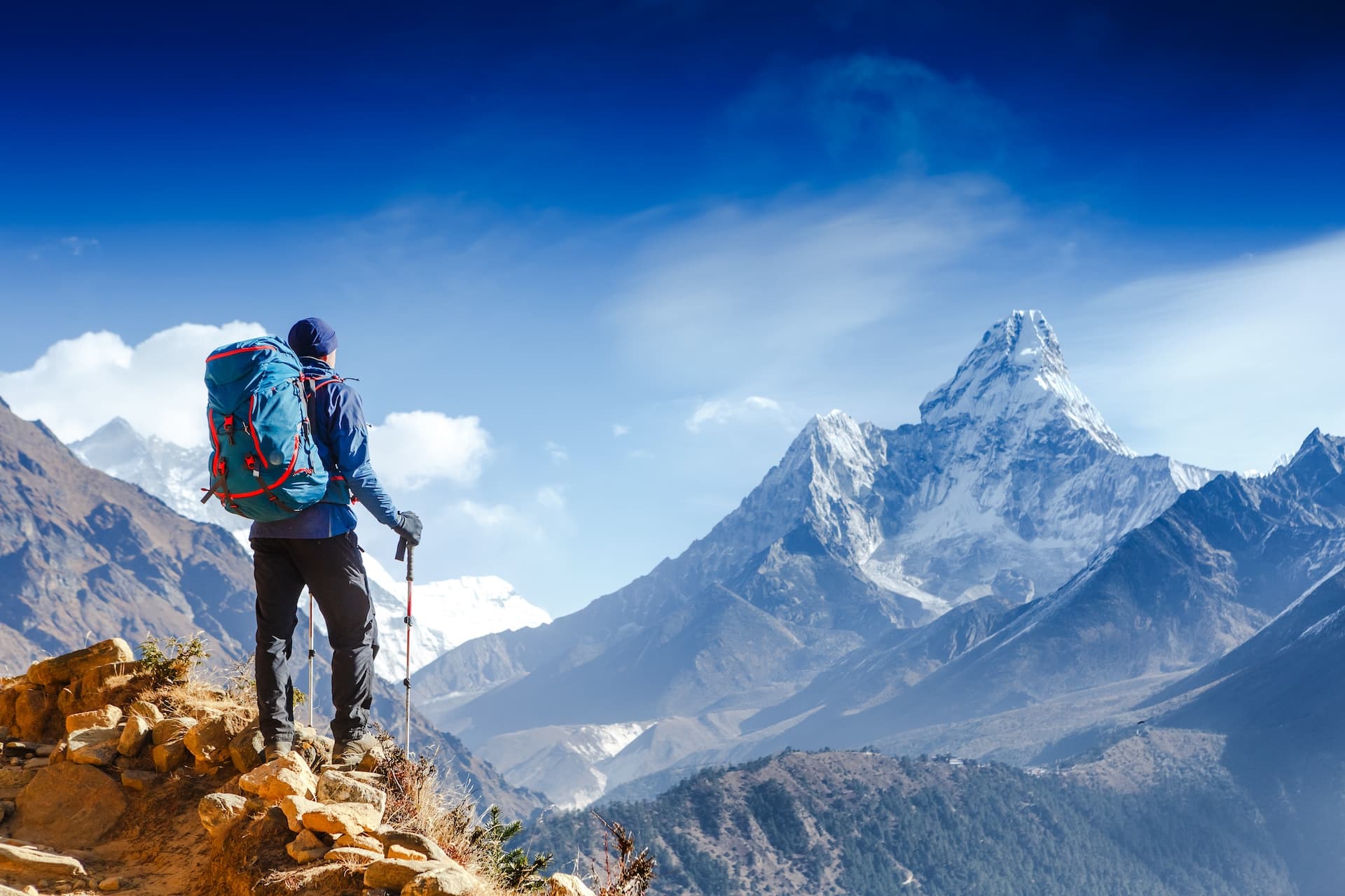 A man stands on the top of a mountain looking at the road ahead representing Coaching Versus Counseling: Why Your Therapist Might Be Keeping You Stuck