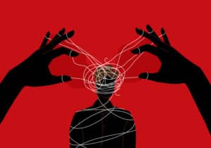 Two hands attached to strings wrapped around a mans mind representing Dark Psychology & Manipulation: Sneaky Tactics Even Smart People Fall For