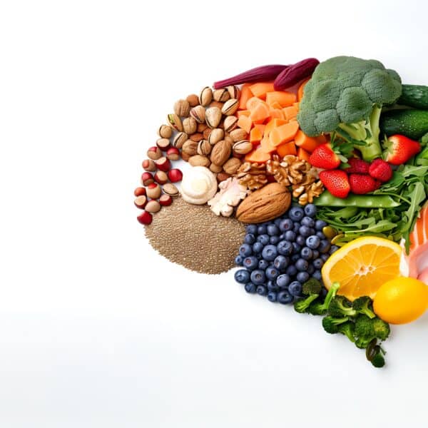 Healthy foods create the shape of a brain representing Beyond the Brain: How Metabolic Psychiatry Is Transforming Mental Health Care.
