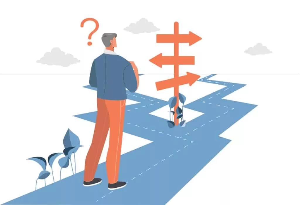 A man standing at a fork in the road representing What Am I Doing With My Life? How to Create a Career Aligned with YOU